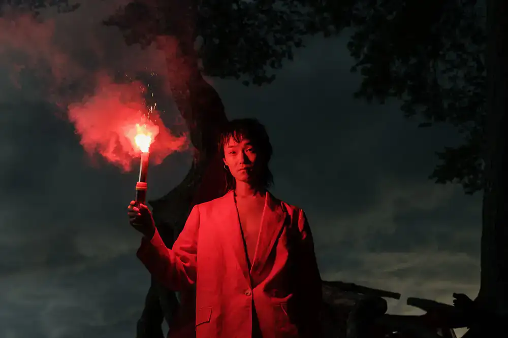 Concept art for Project Veil showing a lone figure holding a flare in dark mist