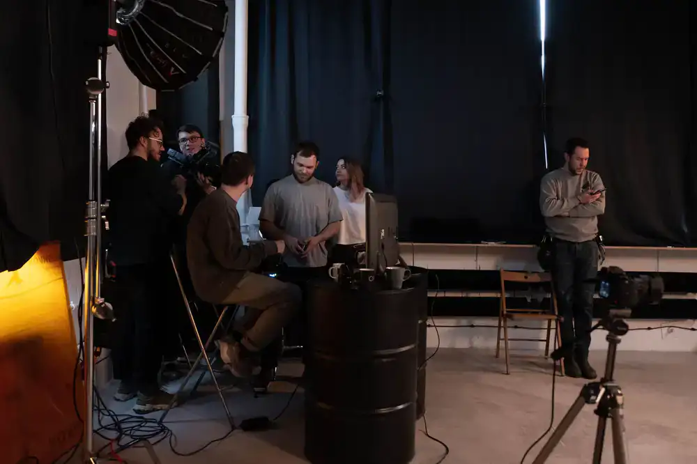 Dimly lit studio environment with monitors glowing
