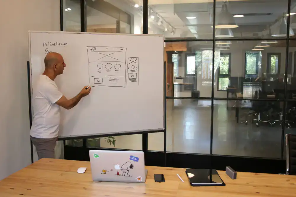 Game designers sketching level layouts on a whiteboard